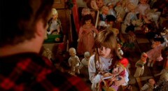 Carrie Lorraine as Judy, holding on to her Punch doll, in Stuart Gordon's creepy fairytale Dolls (1986)