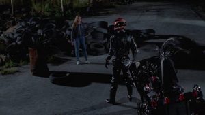 The phantom biker menaces heroine Gail (Sarah Buxton) in Umberto Lenzi's Nightmare Beach (1988)