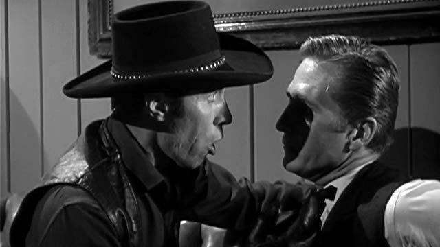 Preacher Dan (Eric Fleming) knows Drake Robey (Michael Pate) is no ordinary man in Edward Dein's Curse of the Undead (1959)