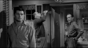 Tensions between Glenn, his brother Hal (Dewey Martin) and thuggish Sam Kobish (Robert Middleton) parallel the Hilliard family's solidarity in William Wyler's The Desperate Hours (1955)
