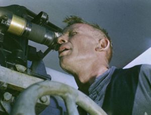 A sailor takes aim at the U-Boat in Pat Jackson's Western Approaches (1944)
