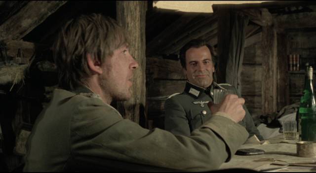 Captain Kiesel (David Warner) offers an ironic toast to newly-arrived Captain Stransky (Maximilian Schell) in San Peckinpah's Cross of Iron (1977)