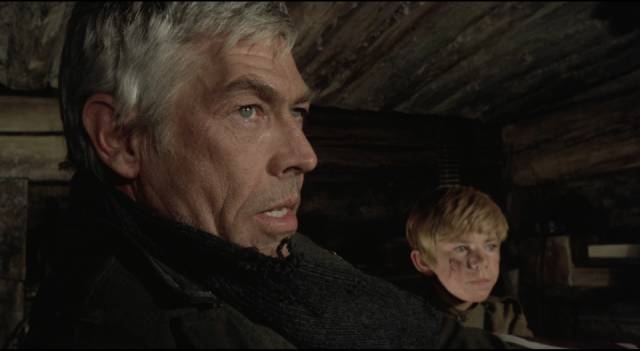 Corporal Steiner (James Coburn) tries to protect a captured Russian boy in Sam Peckinpah's Cross of Iron (1977)