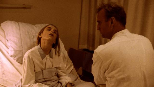 Resident Krogshøj (Søren Pilmark) visits Mona (Laura Christensen) whose brain was damaged by careless surgery in Lars von Trier's The Kingdom II (1997)
