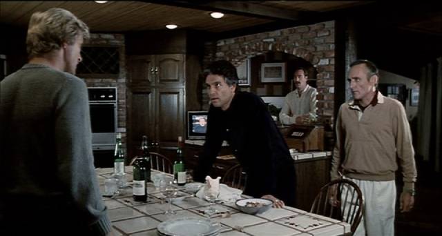 Joseph Cardone (Chris Sarandon), Richard Tremayne (Dennis Hopper) and Bernie Osterman (Craig T. Nelson) confront John Tanner (Rutger Hauer) in Sam Peckinpah's The Osterman Weekend (1983)