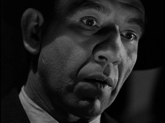 A violent crook (Mike Mazurki) interferes with Don Gale (Richard Dix)'s plans in William Castle's Mysterious Intruder (1946)