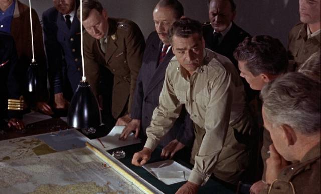 General Mark Grayson (Carl Orrosen) asks for suggestions about how to fight the monster in Reptilicus (1961)