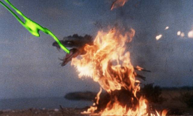 Struck by flamethrowers the monster responds with acid spit in Reptilicus (1961)