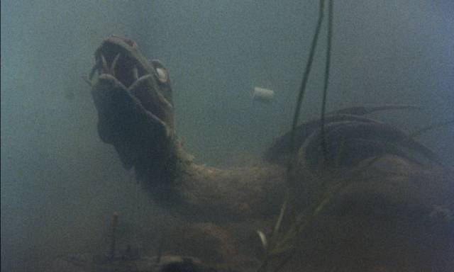 ... and settles on the seabed to recover from the burns in Reptilicus (1961)