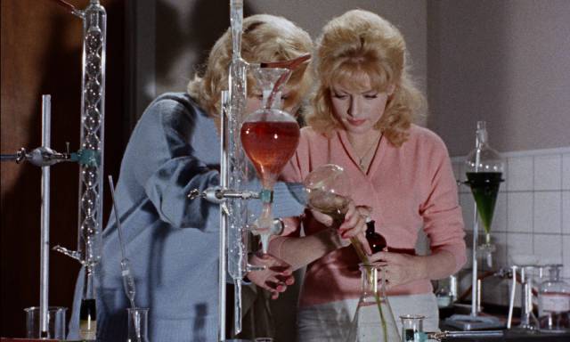 Connie (Marlies Behrens) and Lise (Ann Smyrner) concoct a large dose of tranquilizer in the lab in Reptilicus (1961)