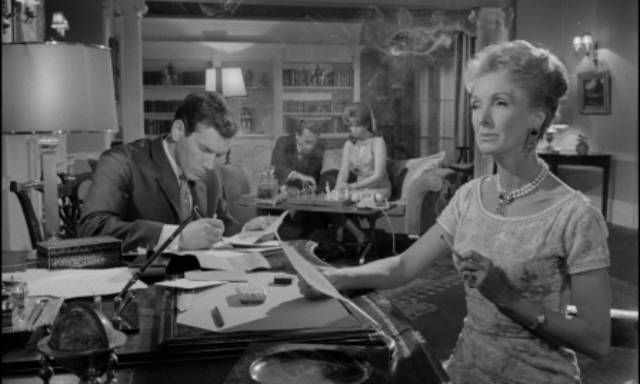 Ellen Garth (Georgina Cookson) dictates to her secretary (Neil McCallum), unaware that her husband (Gary Merrill) and niece (Jane Merrow) are becoming emotionally involved in Gordon Hessler's Catacombs (1965)