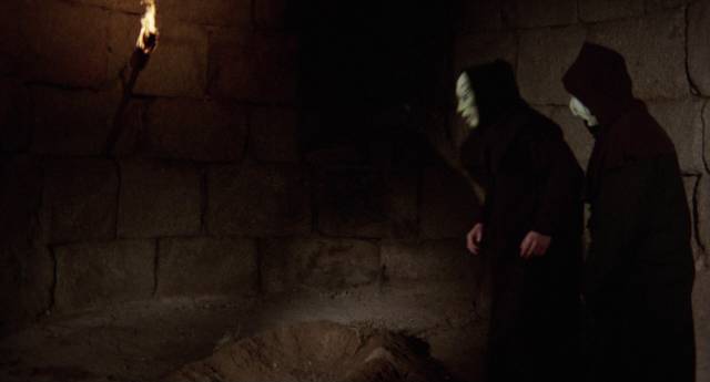 Mysterious hooded figures are growing something strange in the ruins in Miguel Madrid's Necrophagous (1971)