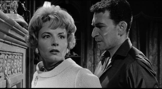 Norman Taylor (Peter Wyngarde) insists that his wife Tansy (Janet Blair) gets rid of all her protective charms in Sidney Hayers' Night of the Eagle (1962)