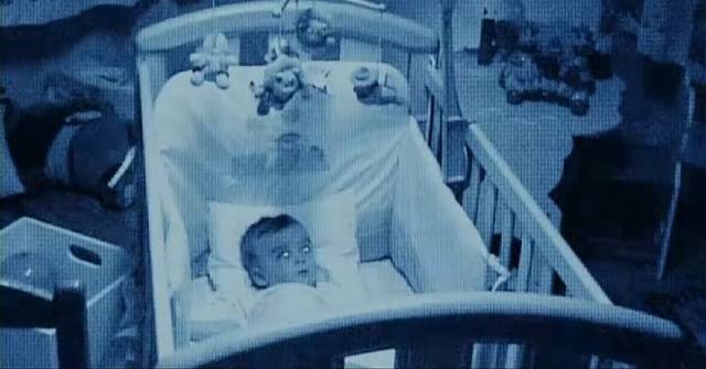 A spectral figure appears on a baby monitor in Álex de la Iglesia's The Baby's Room (2006)