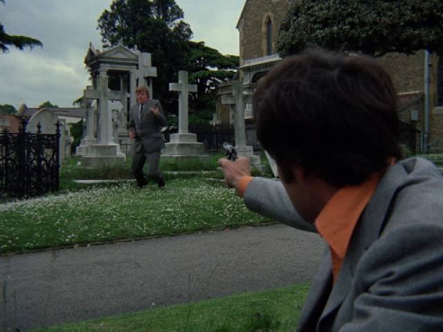 Moon (Michael Latimer) is ambushed in a churchyard in Pete Walker's Man of Violence (1970)