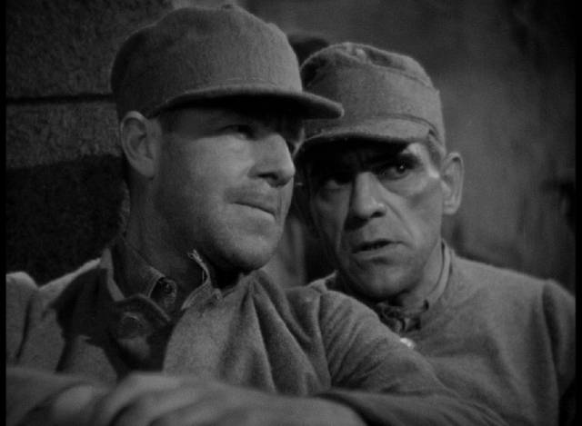 Undercover federal agent Jack Hart (Jack Holt) gets information from convict Jim Henderson (Boris Karloff) in John Francis Dillon’s Behind the Mask (1932)