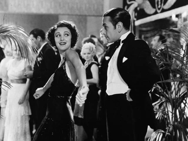 Tony Cramonte (Paul Muni)'s sister Cesca (Ann Dvorak) tries to get Rinaldo (George Raft) onto the dance floor on Howard Hawks' Scarface (1932)