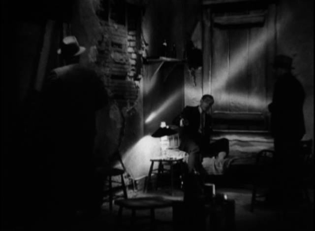 Lee Garmes' chiaroscuro lighting marks the film's sets with analogues of Tony Cramonte (Paul Muni)'s facial scar in Howard Hawks' Scarface 1932)