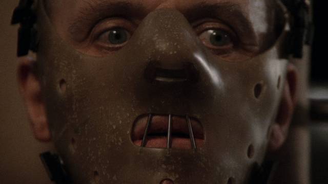 It takes more than a mask to stop Hannibal Lecter (Anthony Hopkins) eating people in Jonathan Demme's The Silence of the Lambs (1991)