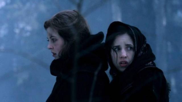 Ginger (Katharine Isabelle) and Bridget (Emily Perkins) are stranded in the wilderness in Grant Harvey's Ginger Snaps Back: The Beginning (2004)