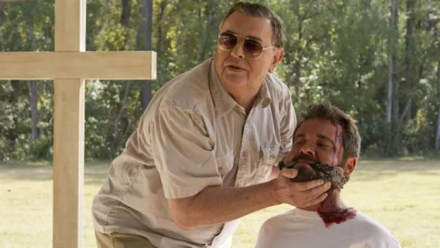 Father (Gene Jones) forces Sam Turner (AJ Bowen) to watch the Hell he's unleashed in Ti West's The Sacrament (2013)