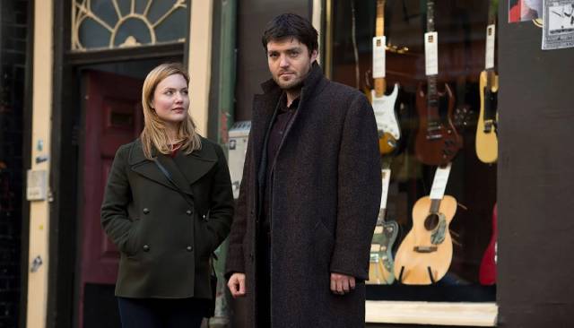 Cormoran Strike (Tom Burke) and Robin Ellacott (Holliday Grainger) investigate a disturbing cold case in Troubled Blood (2022)